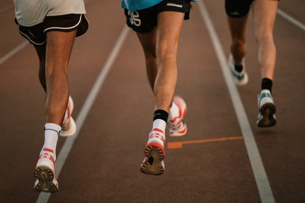 Runners mid-stride on a track