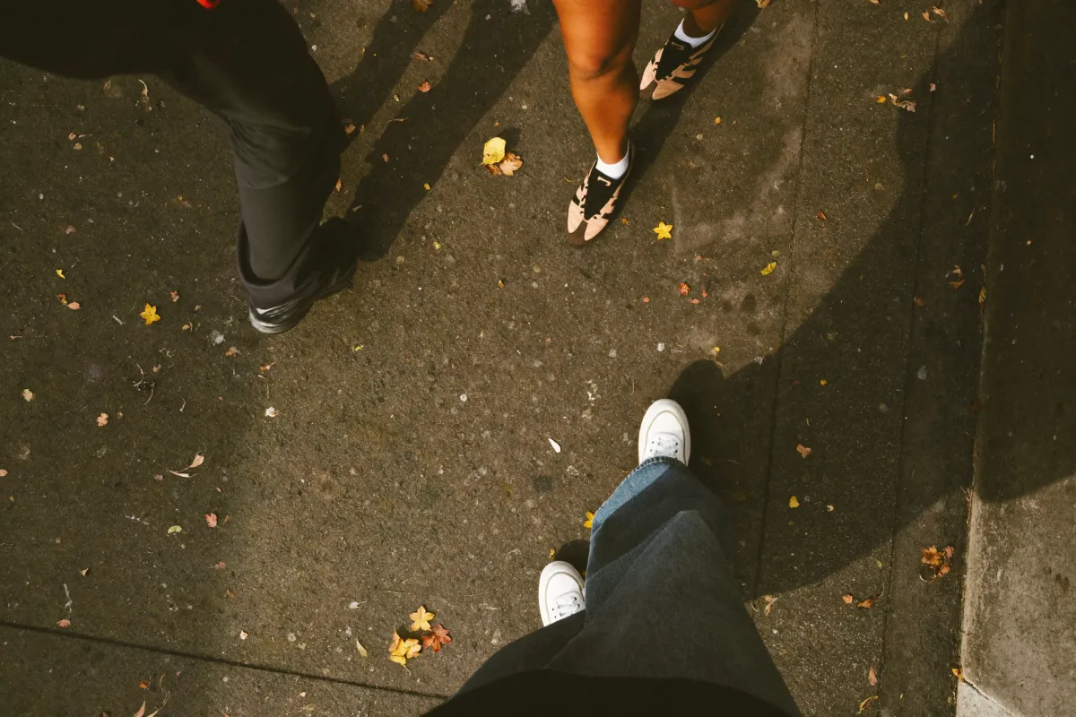 Looking down at people walking on a pavement